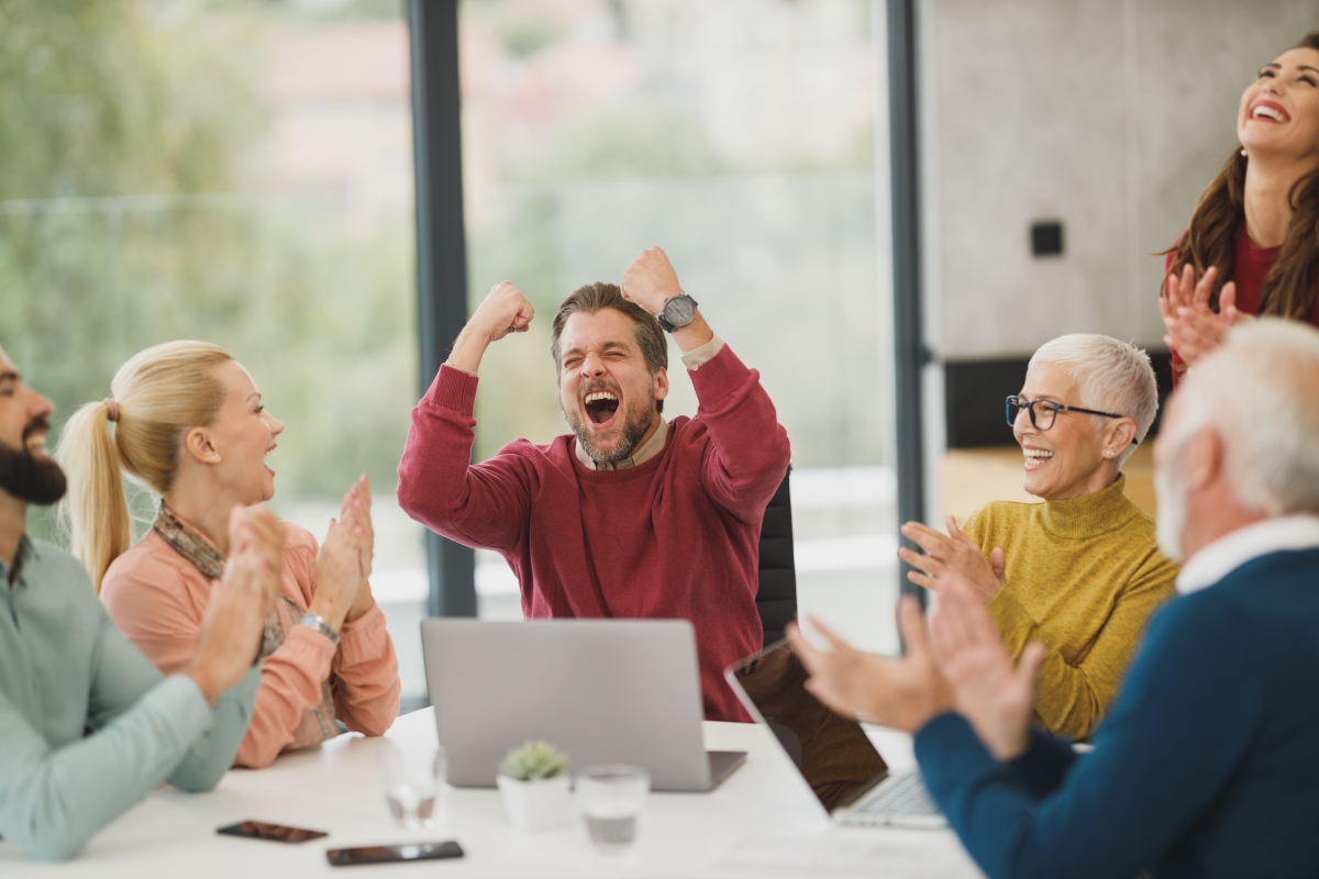 Man in cheering amongst startup colleagues