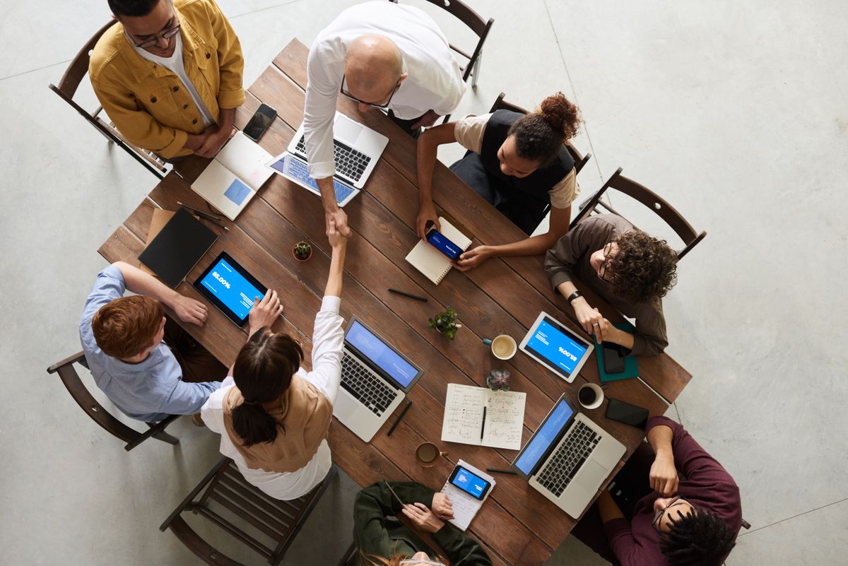 Business owners discussing a proposal at a laptop