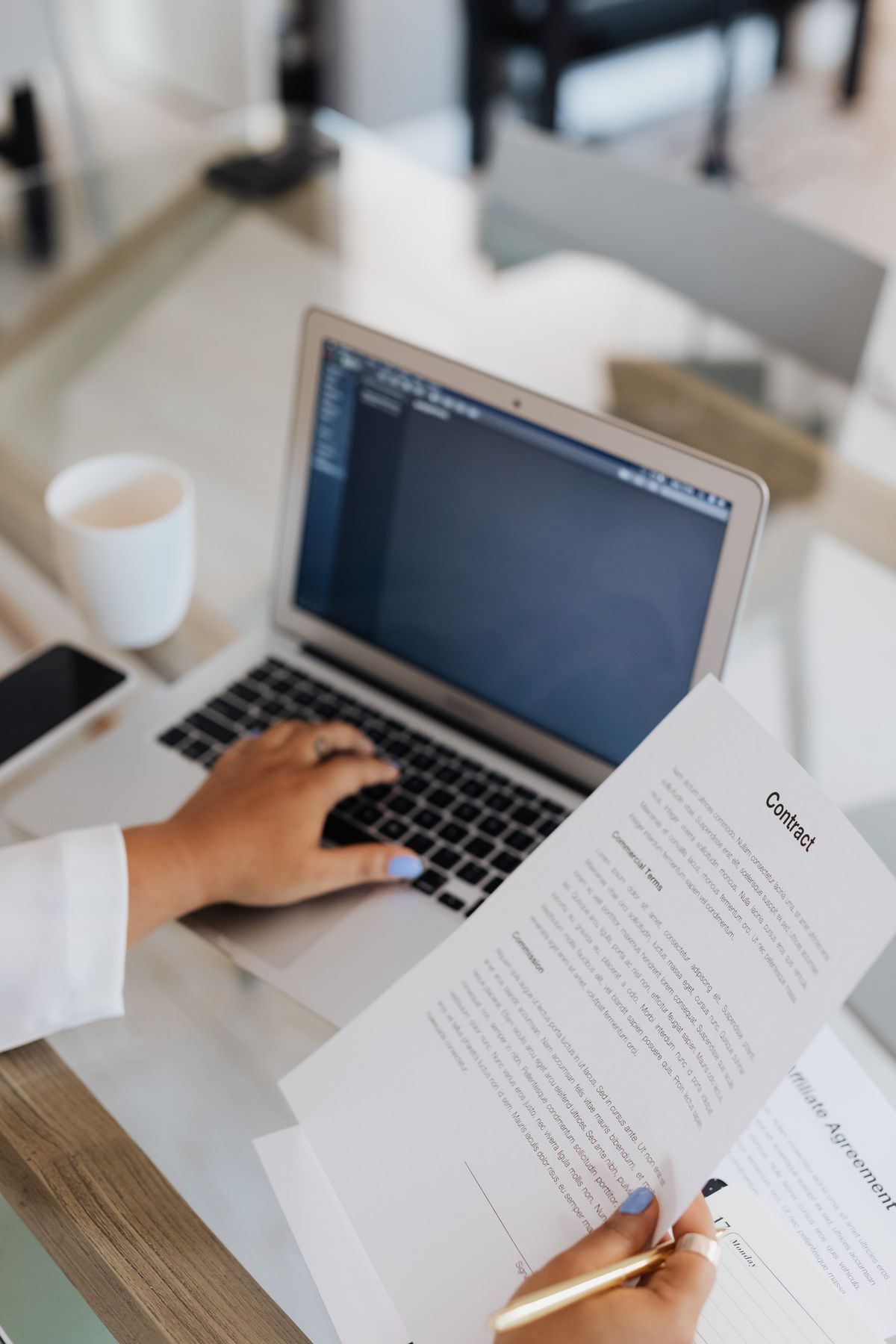 Business owner reviewing a privacy policy document beside a laptop