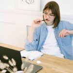 Sole trader working in her home office while weighing up a company structure
