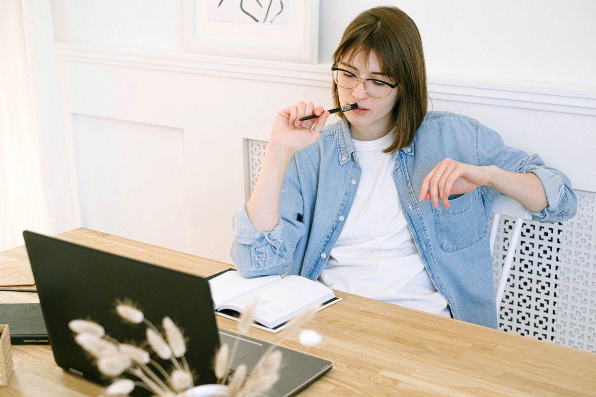 Sole trader working in her home office while weighing up a company structure